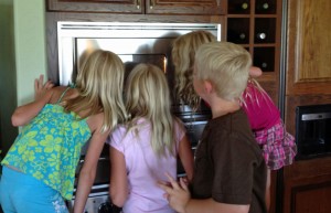 Chris' grandkids gathered around the microwave