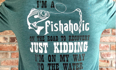 Pazzles DIY Fishaholic Fishing T-shirt with instant SVG download. Instant SVG download compatible with all major electronic cutters including Pazzles Inspiration, Cricut, and Silhouette Cameo. Design by Sara Weber.